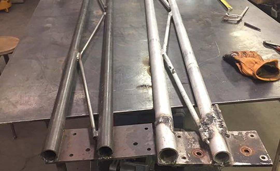 Custom welded steel tubing fabrication on the shop table